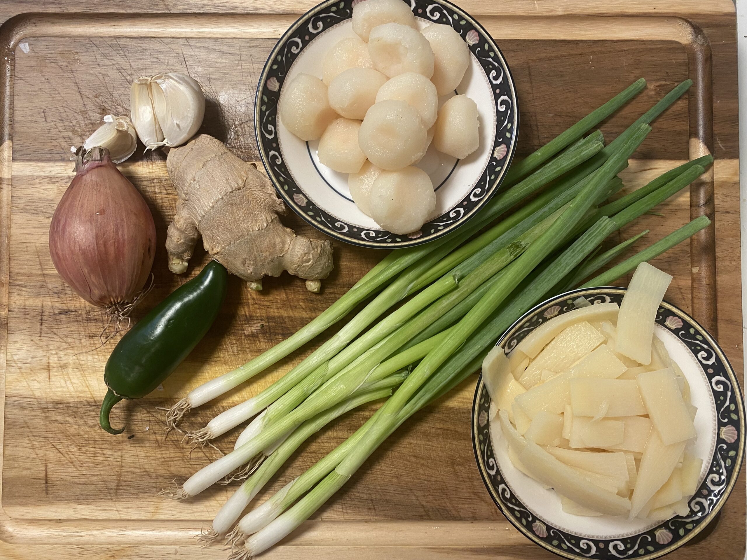 Water chestnuts, bamboo shoots, shallot, jalapeño, ginger, garlic and green onions prepared for lettuce wraps